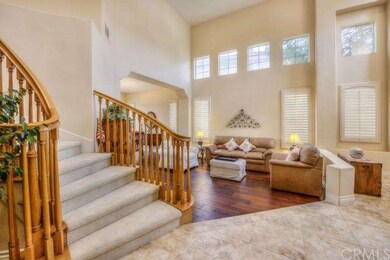 Sweeping staircase leads to the upstairs room.