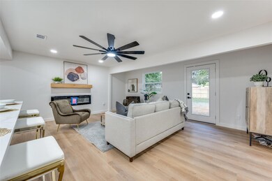 Living room with light hardwood / wood-style floor