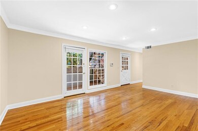 Spare room with ornamental molding, light wood-style floors, and recessed lighting