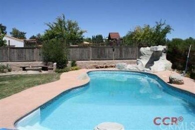Built in fiberglass pool with rock water features.