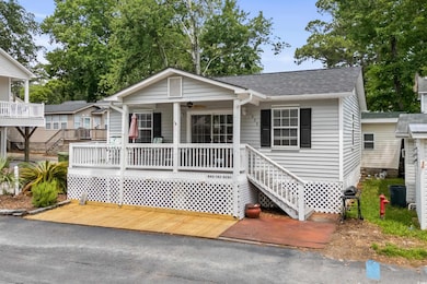 View of front of home featuring a porch, ceiling fan, roof with shingles, and stairs
