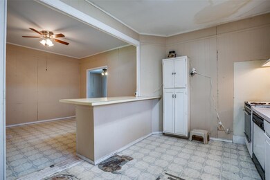 Kitchen with gas stove, white cabinetry, kitchen p
