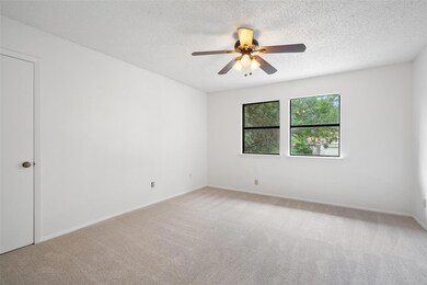 Spare room featuring light carpet, a ceiling fan,