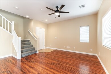 Unfurnished room with stairs, wood finished floors