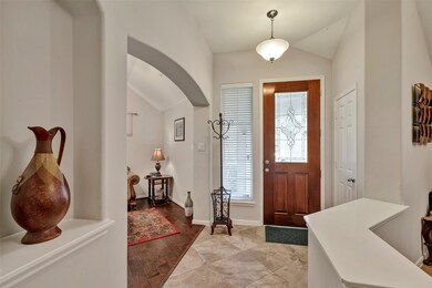 The house features a welcoming foyer, offering a s