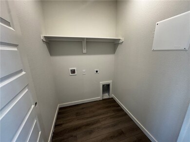 Laundry room featuring hookup for an electric dryer, dark wood-type flooring, and washer hookup