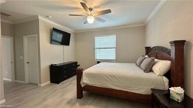 Bedroom featuring light wood finished floors, base