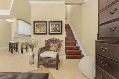Sitting room featuring crown molding, stairway, baseboards, and light tile patterned flooring