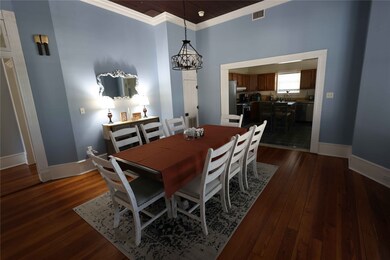 The dining room opens into a kitchen area through