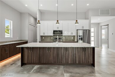 Kitchen with a center island with sink, appliances