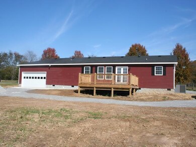 Big deck, covered front porch and double garage.
