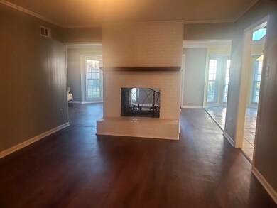 Unfurnished living room featuring dark hardwood / 