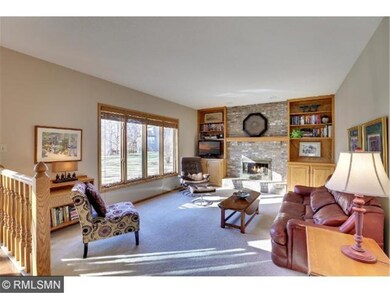 Family room boast gas fireplace flanked with custo