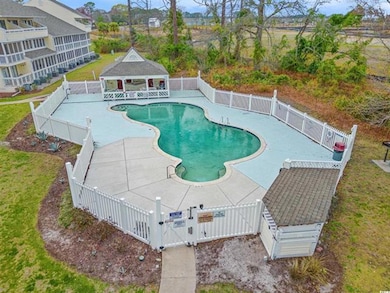 View of swimming pool featuring a gate, a patio ar