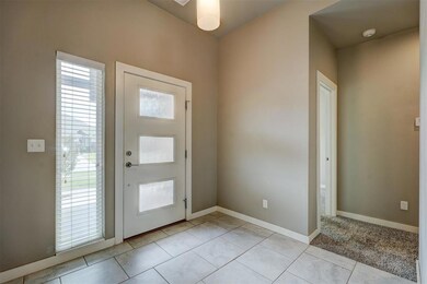 Foyer featuring light colored carpet
