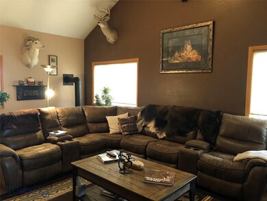 Upstairs living room with vaulted ceilings and ope