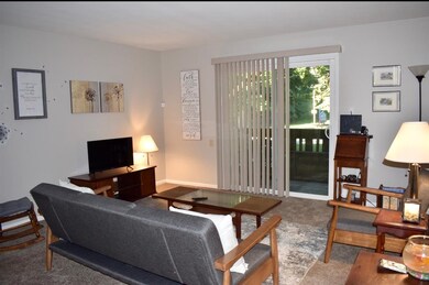 Cozy, open living room with patio door that offers