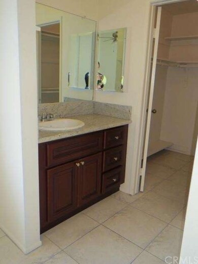 Master bathroom with granite countertop and walk in closet
