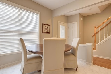 Dining room featuring LVT light marble finish floors and stairway