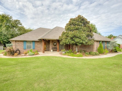 Ranch-style house with a shingled roof, a front yard, brick siding, and covered porch