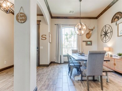 Dining space with an inviting chandelier, arched w