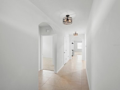 View from the entry door. Tile flooring, Hallway Motion sensor chandeliers