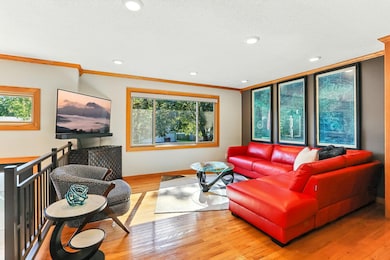 Large living room window offers ample light throughout the upper space. Also features a custom window above new entry door.