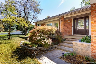Property entrance featuring a yard, brick siding, and a chimney