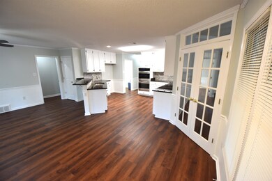 Kitchen featuring white cabinets, stainless steel 
