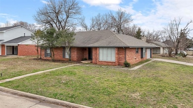Single story home featuring brick siding, a shingl