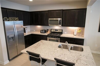Kitchen featuring stainless steel appliances, tas