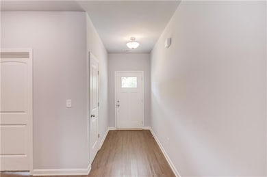 Entryway featuring wood finished floors and baseboards