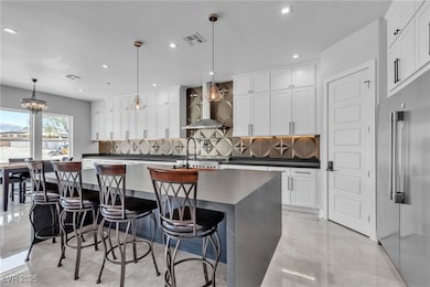 Kitchen with range hood, high end fridge, dark cou