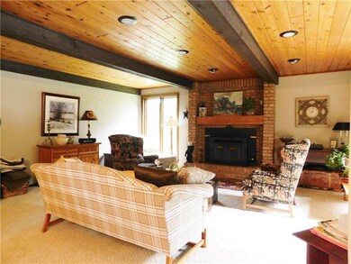 Family room with wood burning fireplace and Pella 