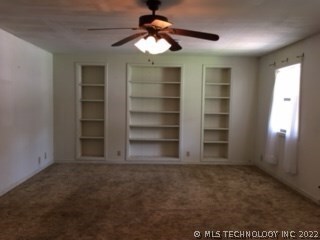 Front living room with built-in book shelves.