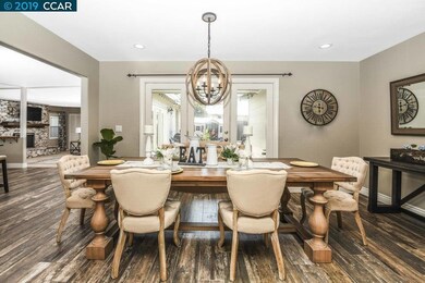 Stunning Dining Room features wood chandelier, rec