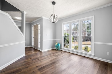 Unfurnished dining area with dark wood-style floor