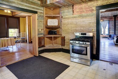 Kitchen featuring gas range, wooden walls, health