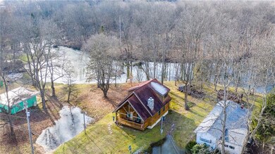 OVERHEAD VIEW SHOWING HOUSE ON LOT SITTING ON RIVE