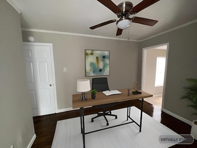 Office space with baseboards, crown molding, ceili
