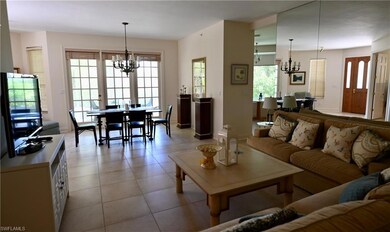 Tiled living room with a chandelier
