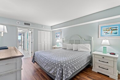 Bedroom featuring a closet and dark hardwood / woo