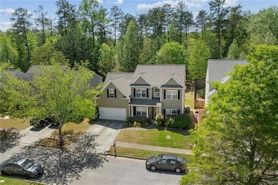 View of front of home with concrete driveway, a ga