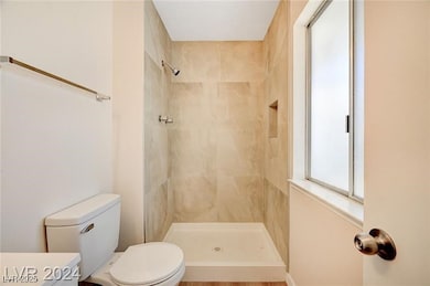 Full bath featuring a tile shower