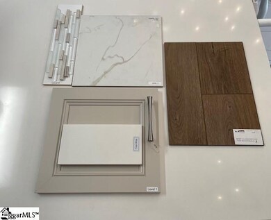 Gray Cabinets, 8ft Ceramic Tile Shower with Deco Band, & LVT floors in the owner's bath