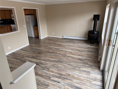 Living room with baseboard heating, dark hardwood