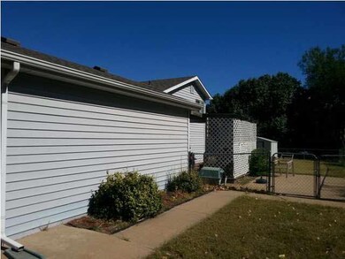 Side view of house and porch off kitchen area.