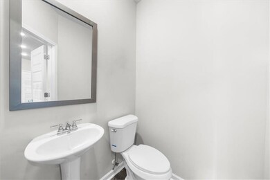 Bathroom with a sink, baseboards, and toilet