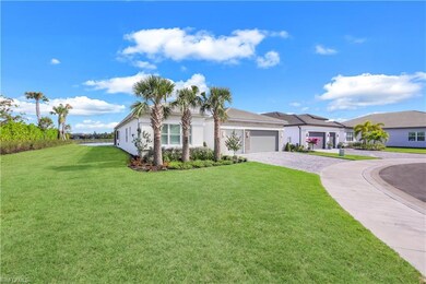 Single story home with a garage and a front lawn