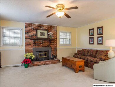 A wood-burning stove does an amazing job of warming the family room, and a ceiling fan keeps the warmth circulating throughout the home.